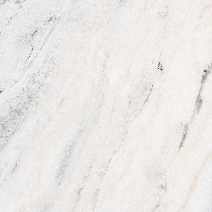 A Close-Up Of A Light-Colored Natural Stone With A Speckled Pattern Of Grey And Beige Tones, Featuring A Polished And Glossy Surface.