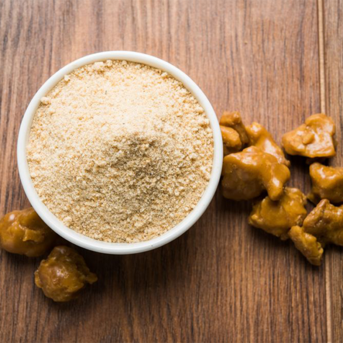 Image Of Asafoetida Powder In A Small Bowl, A Pungent Spice Used In Indian Cuisine, With Its Distinct Yellow Color.