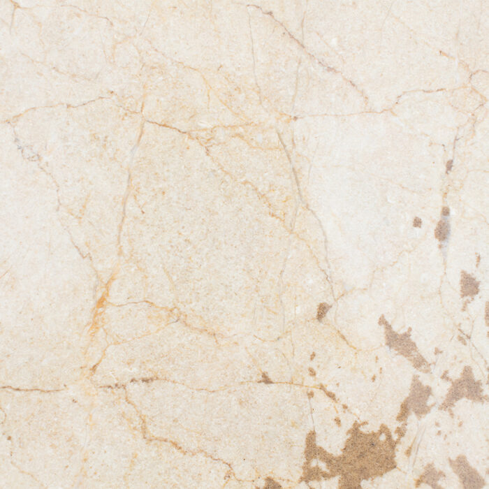 A Close-Up Of A Natural Stone With A Light Cream-Colored Base, Featuring Prominent Patches Of Beige And Grey Mineral Deposits, And A Polished Surface With A Subtle Shine.