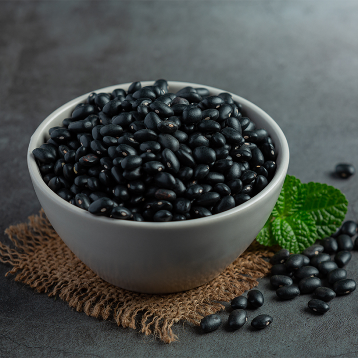 The Beans Are Nestled In A Pool Of Thick, Dark Liquid, Suggesting A Flavorful Broth Or Sauce. Some Beans Are Partially Submerged, While Others Are Fully Visible On The Surface. The Image Conveys The Rich, Hearty Nature Of Black Beans, A Popular Legume Known For Its Distinct Flavor And Versatility In Various Culinary Applications, Such As Soups, Stews, Salads, And Mexican Dishes.