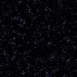 a stunning natural stone with a deep black background and sparkling gold and silver speckles, reminiscent of a starry night sky.