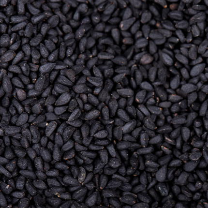 They are dry and uncooked, with a slightly curved shape and a characteristic split on one side. The image showcases the distinct appearance of black matpe beans, a type of lentil commonly used in Indian, Pakistani, and other South Asian cuisines.