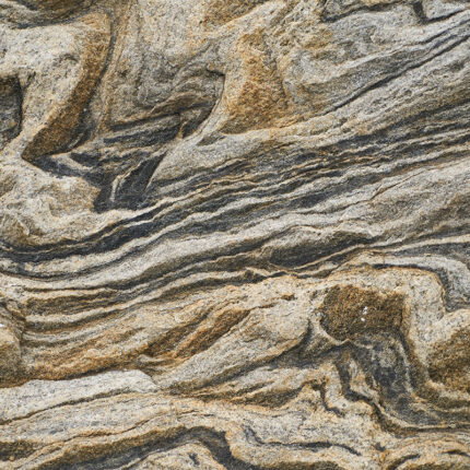 a close-up view of the granite's intricate swirling patterns in shades of brown, gray, white, and black, resembling a stunning work of abstract art.