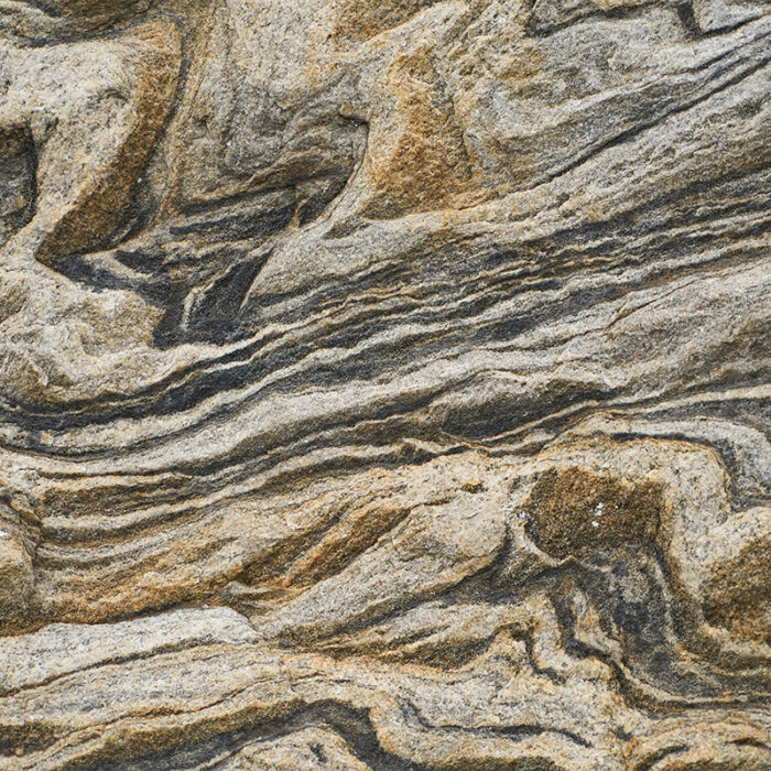 A Close-Up View Of The Granite'S Intricate Swirling Patterns In Shades Of Brown, Gray, White, And Black, Resembling A Stunning Work Of Abstract Art.