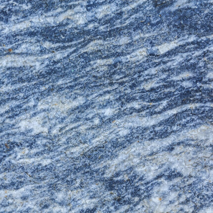 a breathtaking natural stone with a deep blue background and swirling patterns of white and gray, reminiscent of a mountainous landscape.