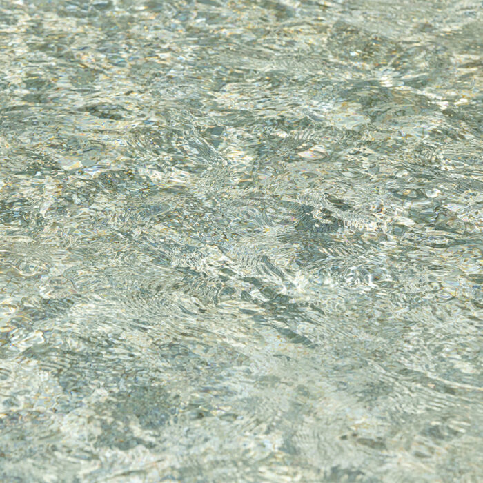 A Close-Up Photograph Of The Natural Stone Surface, Featuring A Mix Of Green And Gray Shades With Small Black And White Speckles Throughout, Creating A Beautiful And Unique Pattern.