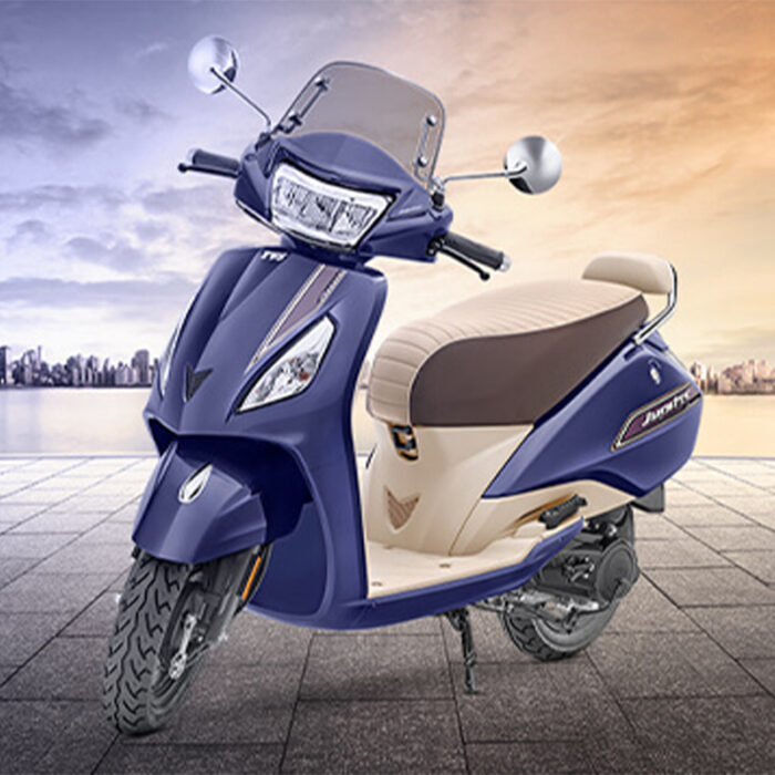 The Scooter Has A Sleek And Elegant Design With A Distinctive Front Apron, A Wide And Comfortable Seat, And A Large Pillion Grab Rail. It Features Telescopic Front Suspension For A Smooth Ride, Alloy Wheels For Stability, And A Fuel-Efficient Engine. The Jupiter Is Known For Its Practicality, Reliability, And User-Friendly Features, Including A Digital Instrument Cluster, External Fuel Filler Cap, And Ample Storage Space, Making It A Popular Choice For Daily Commuting And City Riding.