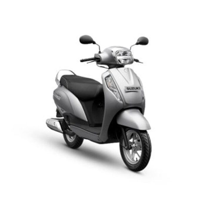 The Scooter Features Sleek Body Design, Large Wheels, And A Spacious Seat. It Has A Digital Instrument Cluster, Front And Rear Disc Brakes, And Led Headlights. The Rider Is Smiling, Indicating A Joyful Riding Experience.