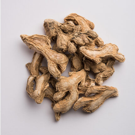 Dry ginger powder in a small dish, commonly used as a spice in baking and cooking, known for its warm and slightly sweet flavor.