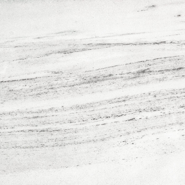 A Close-Up View Of The Marble'S Smooth White Surface With Delicate, Gray Veining Patterns, Resembling The Soft Rumble Of Thunder On A Cloudy Day.