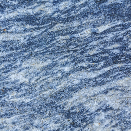 New Himalayan Blue granite slab with a predominantly blue background and grey and beige mineral deposits throughout. The surface has a polished finish and is suitable for use in countertops, flooring, and wall cladding