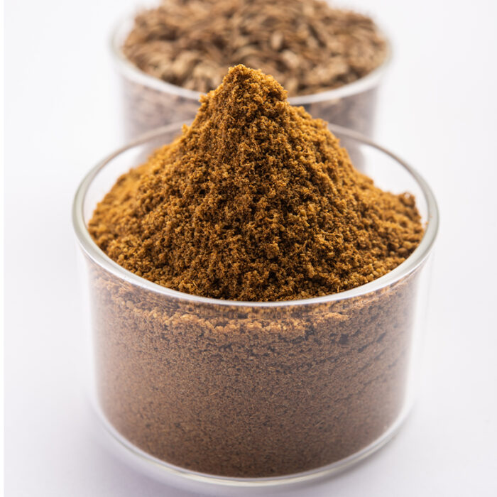 A Pile Of Brownish-Yellow, Fine Powder, Likely Cumin, With A Slightly Granular Texture.