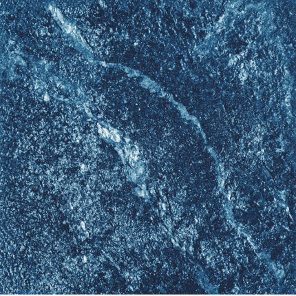 a high-resolution view of the granite's deep blue surface with speckled white and black patterns, resembling the shimmering beauty of a sapphire gemstone.