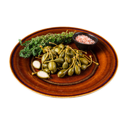 Capers a condiment commonly used in Mediterranean cuisine for its tangy and salty flavor, made from pickled flower buds of the caper bush.
