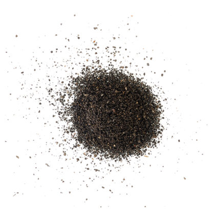 A pile of fine, dark brownish-black powder, likely black pepper, with a slightly granular texture.