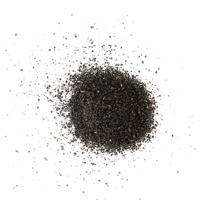 A Pile Of Fine, Dark Brownish-Black Powder, Likely Black Pepper, With A Slightly Granular Texture.