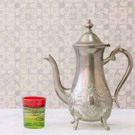 This teapot is often made of metal, such as brass or silver, and features intricate patterns or engravings.