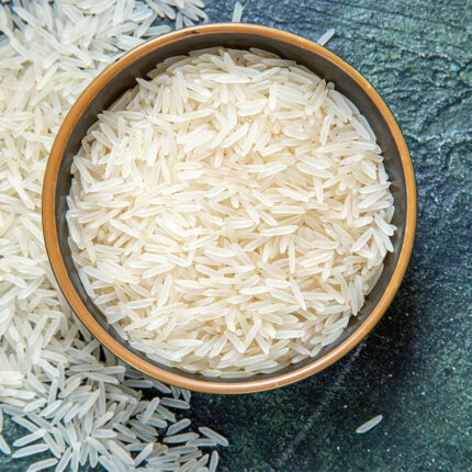 The grains of Basmati rice are long, slender, and white in color. The image may show a bowl of cooked Basmati rice or a pile of uncooked rice grains.