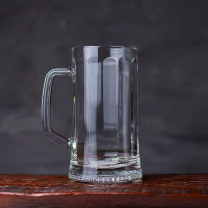 The beer mug is typically made of thick glass, ceramic, or stainless steel, and has a sturdy and robust appearance.
