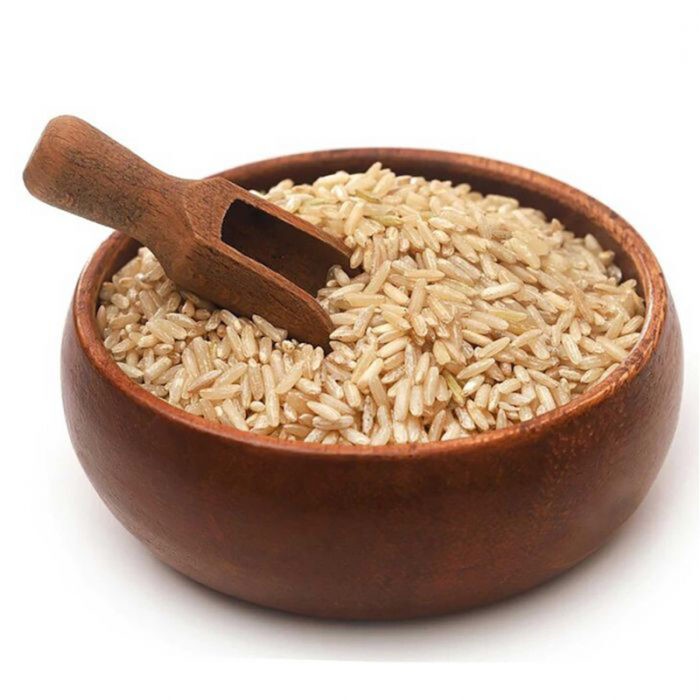 The Image May Show A Bowl Of Cooked Brown Rice Or A Pile Of Uncooked Rice Grains. Brown Rice Retains The Outer Bran Layer And Germ, Giving It A Nutty Flavor And A Slightly Chewy Texture Compared To White Rice. It Is Considered A Healthier Alternative To White Rice As It Contains More Fiber, Vitamins, And Minerals.