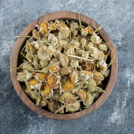 The chamomile flowers are small and daisy-like with white petals and a yellow center. They are dried and arranged in a loose pile, retaining their bright color and fragrance. Chamomile flowers are often used for their calming and soothing properties, and are commonly used in herbal teas, skincare products, and aromatherapy.