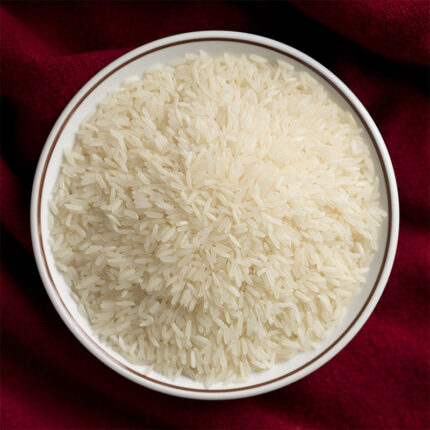 The image may show a bowl of cooked Jasmine rice or a pile of uncooked rice grains. Jasmine rice is commonly used in Southeast Asian cuisines, particularly in Thai, Vietnamese, and Cambodian dishes.