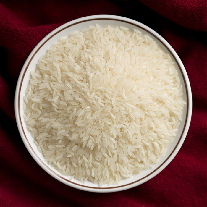 The Image May Show A Bowl Of Cooked Jasmine Rice Or A Pile Of Uncooked Rice Grains. Jasmine Rice Is Commonly Used In Southeast Asian Cuisines, Particularly In Thai, Vietnamese, And Cambodian Dishes.