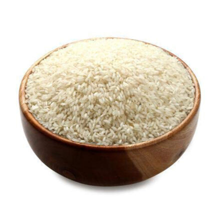Surti Kolam rice or a pile of uncooked rice grains. Surti Kolam rice is known for its pleasant aroma, soft texture, and excellent taste. It is often used in Gujarati cuisine, especially for preparing dishes like khichdi, pulao, and rice-based desserts.
