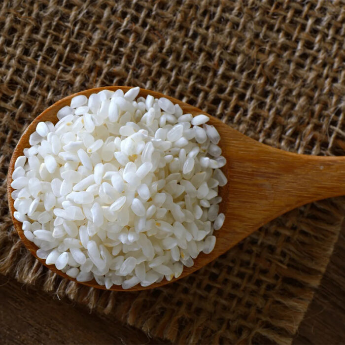 The Image May Show A Bowl Of Cooked Sushi Rice Or A Pile Of Uncooked Rice Grains. Sushi Rice Is Specifically Prepared With A Combination Of Vinegar, Sugar, And Salt To Achieve A Sticky Yet Slightly Tangy Flavor.