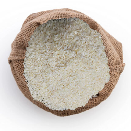 Tulaipanji rice or a pile of uncooked rice grains. Tulaipanji rice is known for its delightful fragrance, delicate flavor, and tender texture. It has a soft and fluffy texture when cooked, with grains that remain separate.