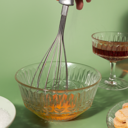 The whip bowl is usually made of stainless steel or glass and features a wide and shallow design to facilitate effective whisking and incorporate air into the mixture.