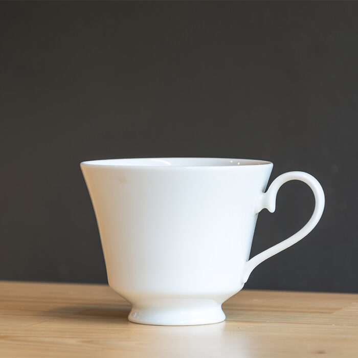 The Coffee Cup Is Typically Made Of Ceramic, Porcelain, Or Glass, And May Feature A Handle For Easy Holding.