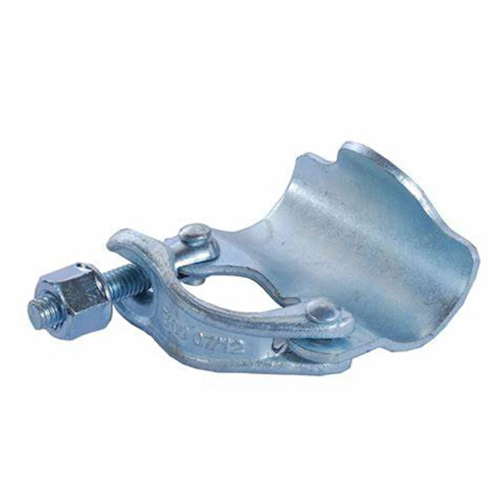 The Coupler Has A Flat, Rectangular Shape And Is Made Of Metal With A Silver Or Gray Finish. It Has A Set Of Jaws That Grip Onto The Scaffold Tube And Another Set That Clamps Onto The Wall Or Surface. The Coupler Can Be Tightened Using A Bolt Or Lever To Hold The Tube Securely In Place.