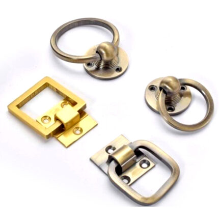 Decorative brass rings designed for easy pulling and opening of drawers, cabinets, or doors.
