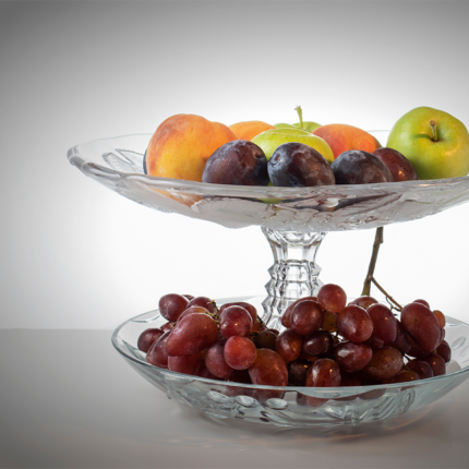 The fruit tray is typically shallow and wide, allowing for easy arrangement and presentation of different fruits.