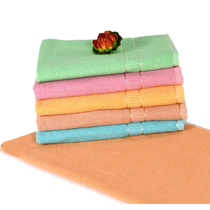 A Luxurious Goldy Crape Towel Made Of Soft And Absorbent Fabric. The Towel Has A Golden-Yellow Color With A Crinkled Or Crepe-Like Texture, Adding A Unique And Stylish Touch To Your Bathroom Or Beach Accessories.