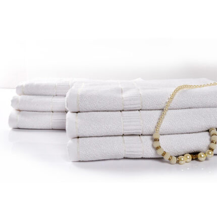 A milky white towel made of soft and absorbent fabric. The towel has a pristine white color, giving it a clean and fresh appearance