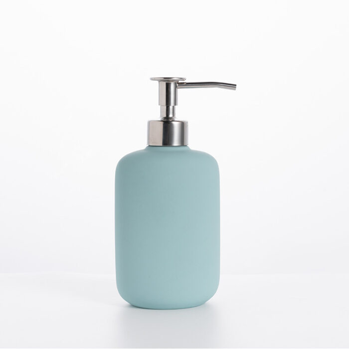 A Sleek And Modern Soap Dispenser Made Of Durable Materials. The Dispenser Has A Cylindrical Shape With A Pump Mechanism On Top For Easy Dispensing Of Liquid Soap.