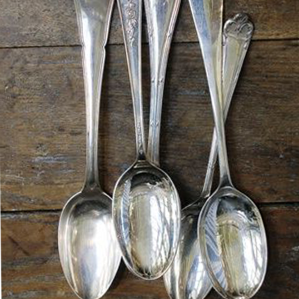 A standard table spoon, a common utensil used for measuring and serving food. It has a moderate-sized, oval-shaped bowl at one end and a handle at the other, making it suitable for various dining and cooking purposes.