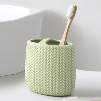 A toothbrush holder designed to hold and store toothbrushes in a bathroom or other similar settings. The holder typically consists of a base or container with separate compartments or slots for individual toothbrushes.